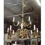 A BRASS "DUTCH" TWO TIER CHANDELIER, with eight lower branches and four upper, 58cm high x 68cm wide