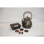 A JAPANESE MEIJI PERIOD BRONZED TEAPOT AND COVER, with raffia type carrying handle, the sides