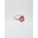 A PINK STONE SOLITAIRE RING, the large central emerald cut stone possibly spinel, measuring c.11.2mm