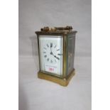 A 19TH CENTURY BRASS CASED FRENCH CARRIAGE CLOCK, visible escapement, white enamel dial