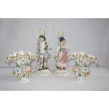 A PAIR OF 19TH CENTURY CONTINENTAL CERAMIC CANDLESTICKS, in the form of a man and woman in