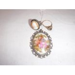 A YELLOW METAL DRESS RING set with a red stone, a silver cameo ring and a hand painted limoges