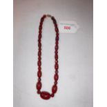 A GRADUATED 'AMBER' AND GLASS BEAD NECKLACE, length 40.64cm