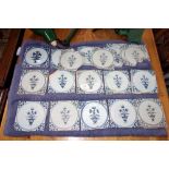 A COLLECTION OF 18TH CENTURY DELFT BLUE AND WHITE TILES each decorated with a vase of flowers