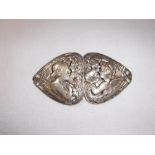 A SILVER ART NOUVEAU TWO PIECE BUCKLE decorated with cut out winged cherubs and flowers