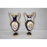 A PAIR OF 19TH CENTURY CONTINENTAL PORCELAIN VASES with Royal blue and gilt decoration and floral