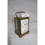 A 19TH CENTURY BRASS CASED CARRIAGE CLOCK, with white enamel dial and subsidiary dial, sticking on a