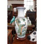 AN ORIENTAL VASE 45 cm high (drilled to the base) on a wooden stand,