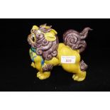 A CHINESE BRIGHTLY DECORATED DOG OF FO, with a yellow glazed body, 15cm high