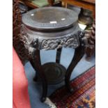 A CHINESE CARVED AND EBONISED JARDINIERE STAND, the circular top 39cm diameter