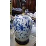 A CHINESE BLUE AND WHITE TABLE LAMP on a carved hardwood stand with brass fittin