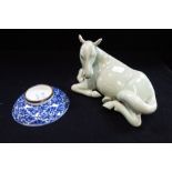 A CHINESE CELADON STUDY OF A HORSE and a small Oriental shallow dish, with a fou