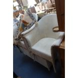 A PAIR OF LLOYD LOOM STYLE WHITE PAINTED ARMCHAIRS, a similar ottoman and a wool