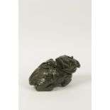 A CHINESE CARVED JADE/GREENSTONE FIGURE OF A FO DOG, 19th/20th century, 25cm lon