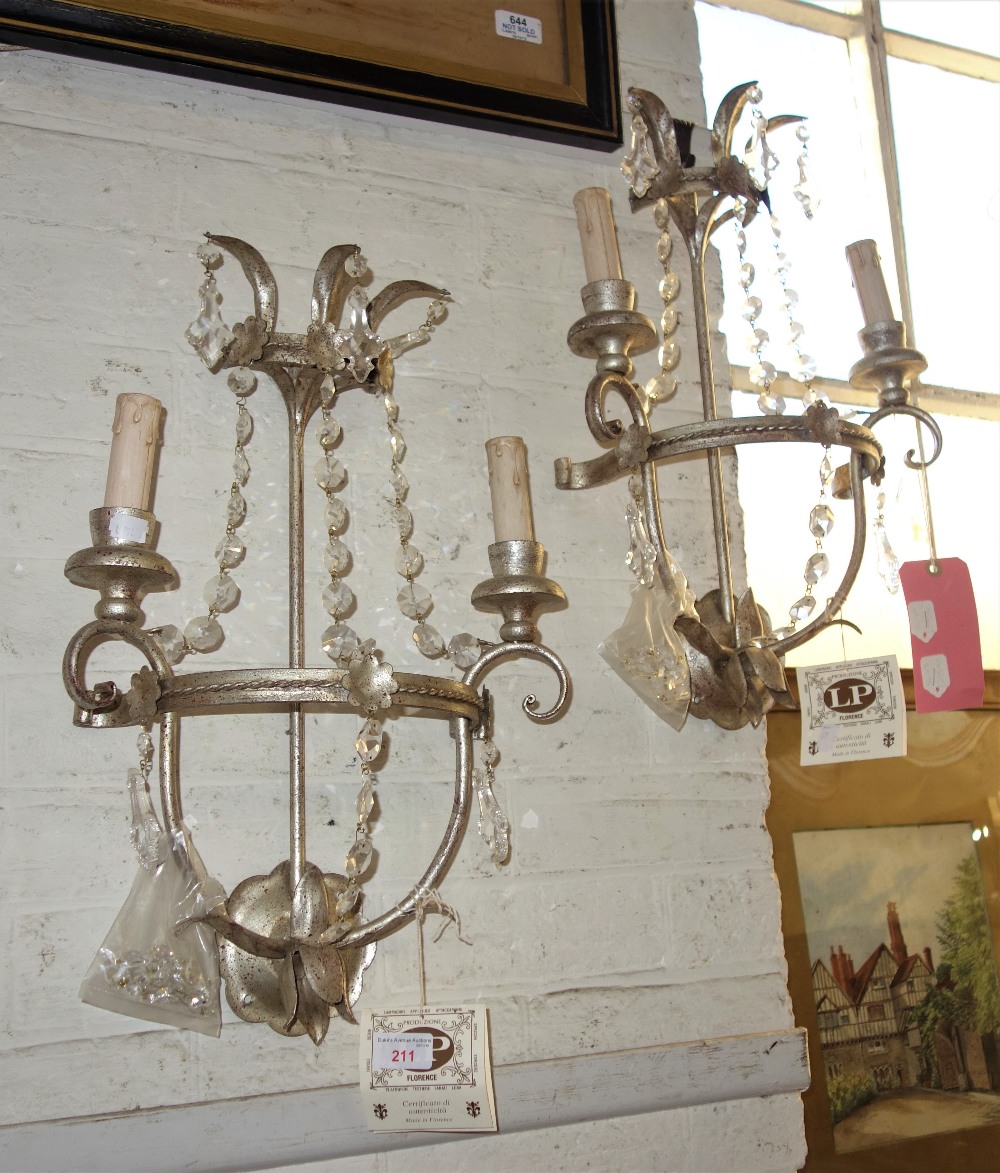 A PAIR OF FLORENTINE WALL LIGHTS with silver painted decoration and cut glass dr