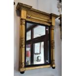 A REGENCY GILT FRAMED OVERMANTLE OR PIER MIRROR, the pilasters with leaf termina