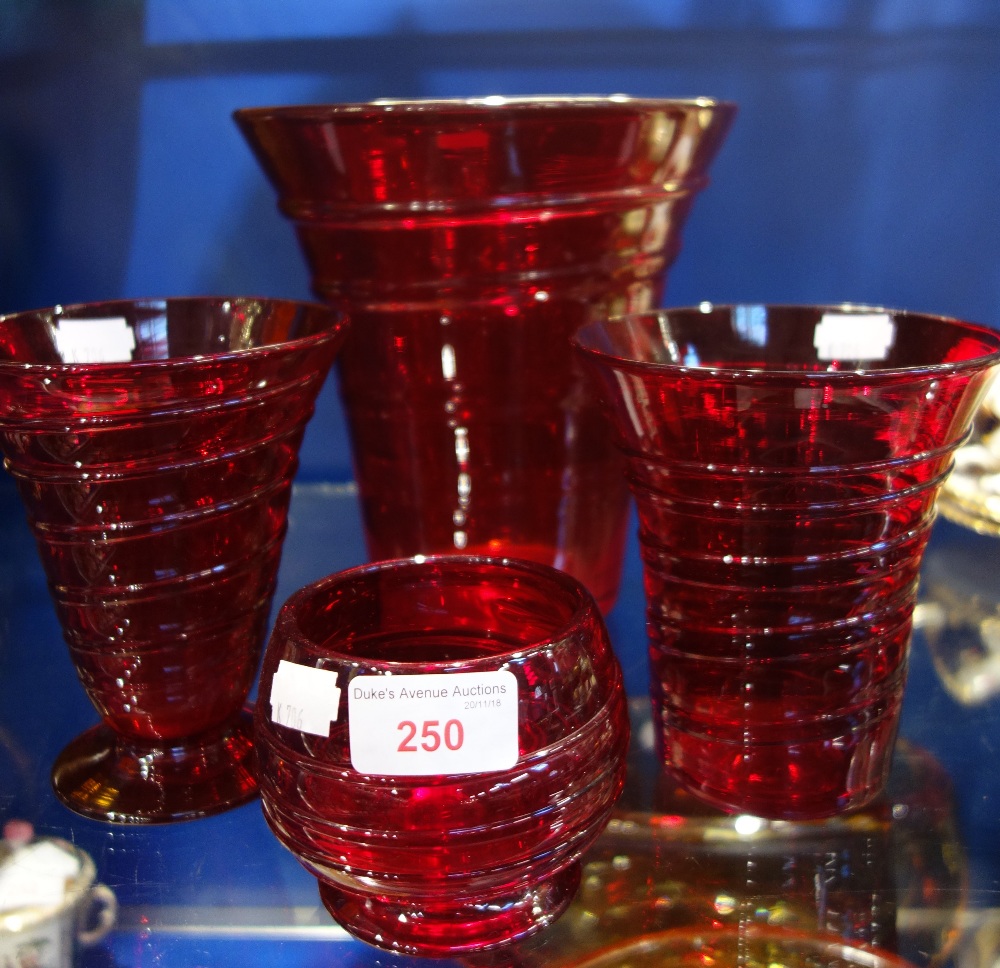 WHITEFRIARS; A COLLECTION OF RED GLASS VASES with spiral decoration (4)