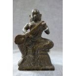 AN INDIAN CARVED STONE FIGURE, seated and holding a stringed instrument, early 20th century, 19.