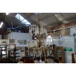 A GILT METAL SIX BRANCH CHANDELIER hung all over with prismatic drops approx. 50cm drop (plus