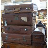 A COLLECTION OF LEATHER AND SIMILAR VINTAGE SUITCASES and an Edwardian Singer sewing machine