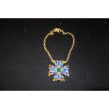 VOGUE: A multi-coloured paste pendant necklace, the pendant reverse stamped 'Vogue', attached to a