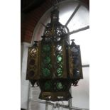 A MOROCCAN BRASS AND COLOURED GLASS STAR SHAPED HALL LANTERN