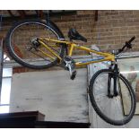 A YELLOW MOUNTAIN BIKE with helmets