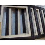 A SET OF FOUR EDWARDIAN OAK REEDED PICTURE FRAMES with cream painted inserts