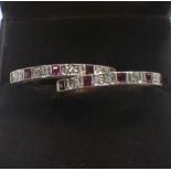 A RUBY AND DIAMOND HALF ETERNITY RING and one other similar ring, both rings size O