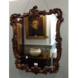 A VICTORIAN ROCOCO STYLE WALNUT FRAMED WALL MIRROR, 59cm wide