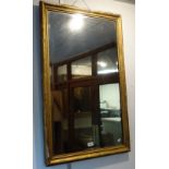 A GILT FRAMED RECTANGULAR WALL MIRROR, the old plate with shallow bevel, 61cm x 94cm