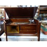 A VINTAGE GRAMOPHONE in a fitted mahogany case, 57cm wide with a collection of 78s