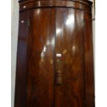 A GEORGE III MAHOGANY BOWFRONTED CORNER CABINET