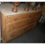 A CONTINENTAL STRIPPED PINE CHEST OF THREE LONG DRAWERS with stamped metal fittings, 140cm wide