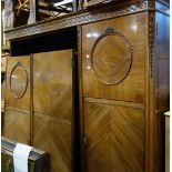 A 1930'S WALNUT TRIPLE WARDROBE with fitted interior by Maple & Co, 173cm wide