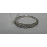 A HALF DIAMOND ETERNITY RING IN PLATINUM, ring size T