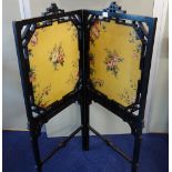 A VICTORIAN EBONISED TWO-FOLD SCREEN with yellow material panels