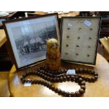 A SET OF RUSSIAN MATRYOSHKA DOLLS, two strings of turned wooden beads, a framed collection of