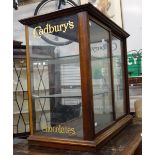 A VICTORIAN MAHOGANY SHOP COUNTER DISPLAY CABINET, the glazed side panels with "Cadbury's Chocolate"