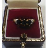 A THREE STONE SAPPHIRE DRESS RING, on an 18ct yellow gold shank with diamond shoulders, ring size N