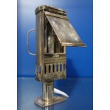 AN EDWARDIAN SILVER PLATED CANDLE HAND LAMP, with fold down cover and armorial crest, 18.5cm high