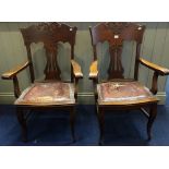 A PAIR OF EDWARDIAN OAK ARMCHAIRS, with pierced splats and carved decoration, each 68cm wide