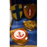 A PAINTED AND GILT OAK MOUNTED ARMORIAL SHIELD by A.W. Crisp & Co., Cambridge and three similar