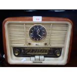 A VINTAGE "TELEFUNKEN" RADIO, also fitted a clock, circa 1950s