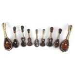 Nine tortoiseshell ivory and Mother of Pearl miniature musical instruments, the largest 20cm in