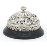 Victorian silver table bell by William Comyns, with ebonised based, embossed and pierced with