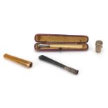 Three cheroots together with a silver cheroot end with silver case, the cheroots comprising one with