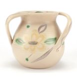 Trial Susie Cooper three handled pottery tyg hand painted with stylised flower heads and leaves,