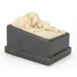 Classical white marble carving of a sleeping nude boy, raising on an ebonised base, 15cm H x 19cm