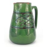 C H Brannam pottery jug made for Liberty & Co, incised with a Celtic design, impressed marks to